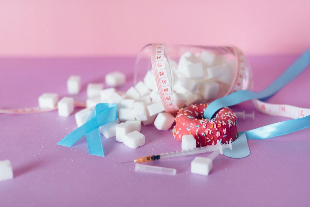 Pink and blue theme on diabetes awareness with sugar cubes and medical ribbons.